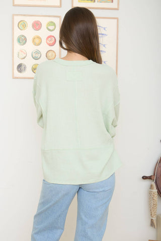SPLIT NECK RAW EDGE LONG SLEEVE RIBBED KNIT TOP