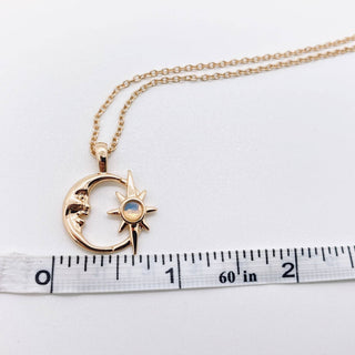 Gold plated necklace with a hollow crescent moon and star pendant set with an opal, view 4