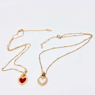 Gold plated stainless steel necklace with a two-sided enamel heart pendant, black on one side, pink on the other, view 3