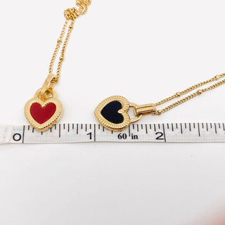 Gold plated stainless steel necklace with a two-sided enamel heart pendant, black on one side, pink on the other, view 4