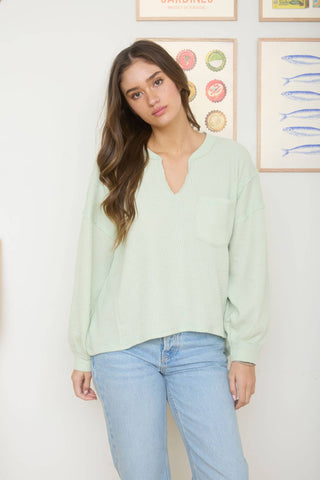 SPLIT NECK RAW EDGE LONG SLEEVE RIBBED KNIT TOP