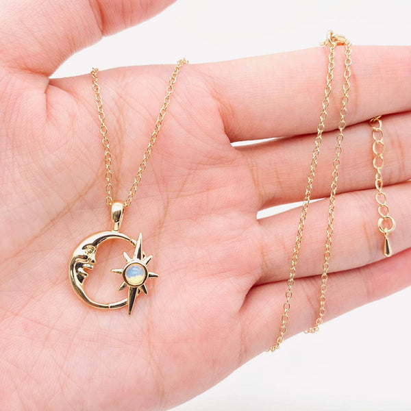 Gold plated necklace with a hollow crescent moon and star pendant set with an opal